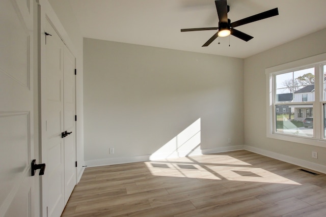 empty room featuring light wood-type flooring and ceiling fan