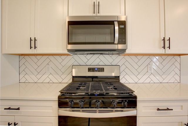 kitchen featuring tasteful backsplash, white cabinetry, and appliances with stainless steel finishes