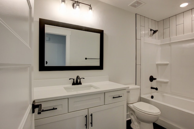 full bathroom featuring vanity, tiled shower / bath combo, and toilet