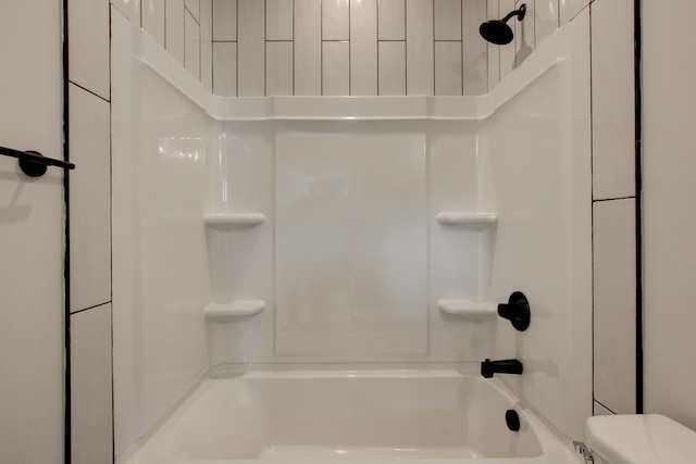 bathroom with toilet and bathtub / shower combination