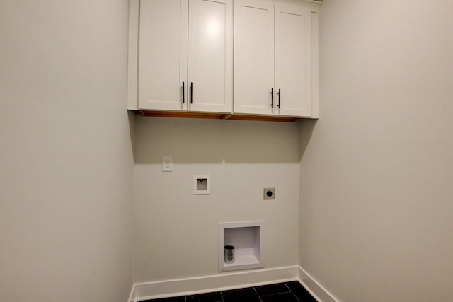 washroom featuring cabinets, washer hookup, hookup for an electric dryer, and dark tile patterned floors