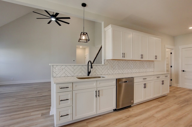 kitchen featuring light hardwood / wood-style floors, white cabinets, sink, stainless steel dishwasher, and backsplash