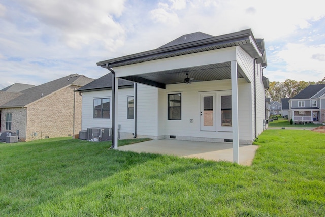 rear view of house with ceiling fan, a lawn, cooling unit, and a patio