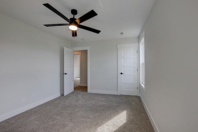 unfurnished bedroom featuring carpet and ceiling fan