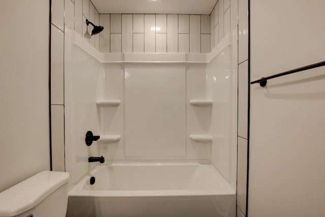 bathroom featuring toilet and tiled shower / bath combo