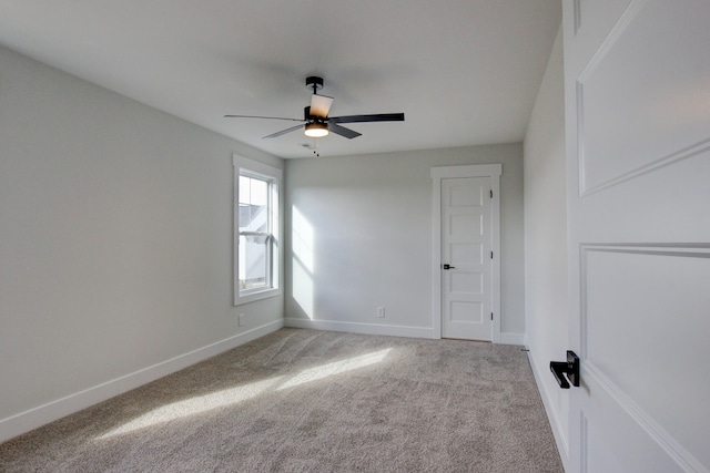 unfurnished room featuring ceiling fan and light carpet