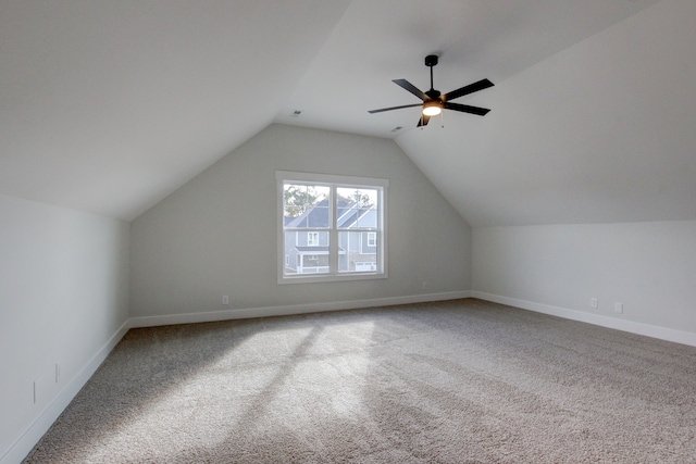 additional living space featuring carpet, ceiling fan, and vaulted ceiling