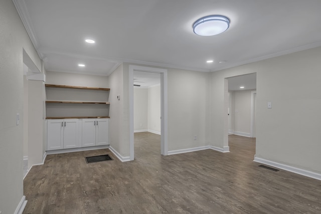 interior space with dark wood-type flooring and ornamental molding