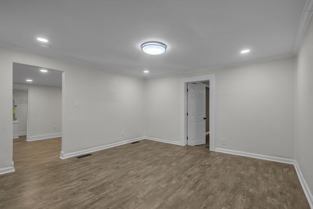 unfurnished room featuring ornamental molding and hardwood / wood-style floors