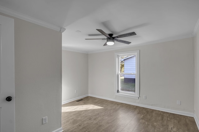 empty room featuring ornamental molding, hardwood / wood-style floors, and ceiling fan