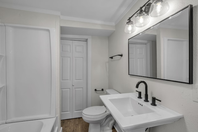 full bathroom with toilet, bathtub / shower combination, ornamental molding, hardwood / wood-style floors, and sink