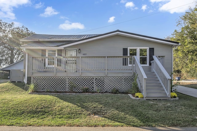 view of front of house featuring a front yard and a deck