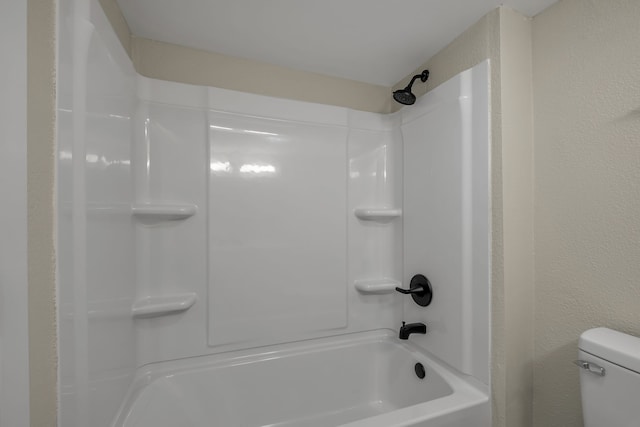 bathroom featuring toilet and  shower combination