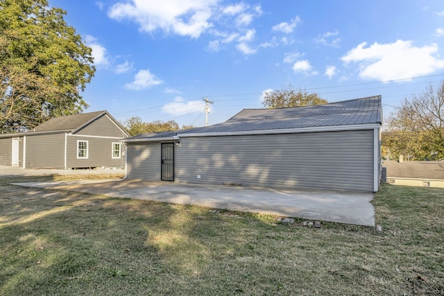 rear view of property featuring a lawn