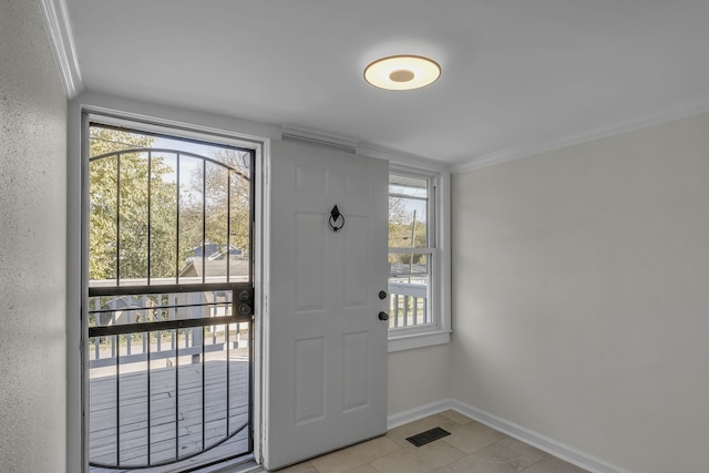 doorway with crown molding and light tile patterned floors