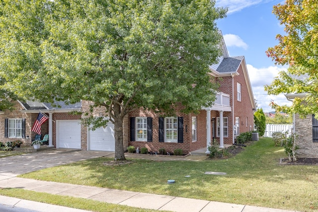 view of front of property featuring a front yard and a garage