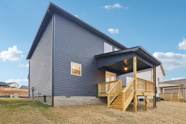 rear view of property featuring a deck, central AC unit, and crawl space