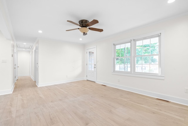 spare room featuring ceiling fan, ornamental molding, and light hardwood / wood-style flooring