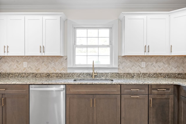 kitchen featuring stainless steel dishwasher, sink, white cabinetry, and light stone counters