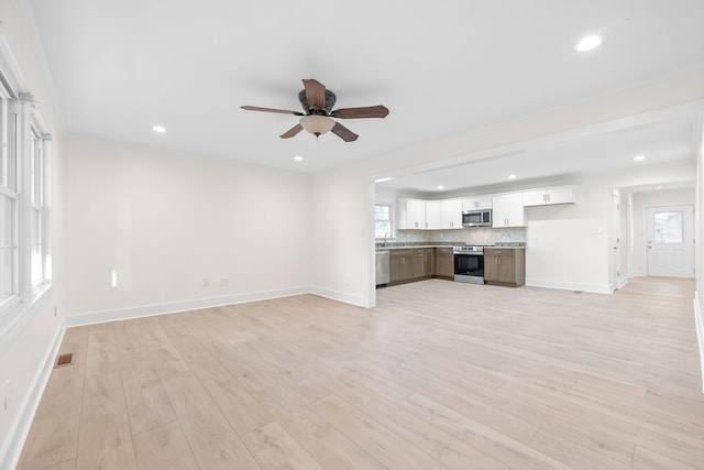 unfurnished living room with light hardwood / wood-style floors and ceiling fan