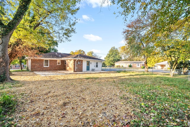 back of house featuring a patio and a lawn