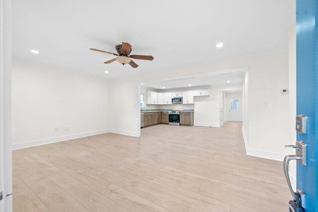 unfurnished living room with light wood-type flooring and ceiling fan