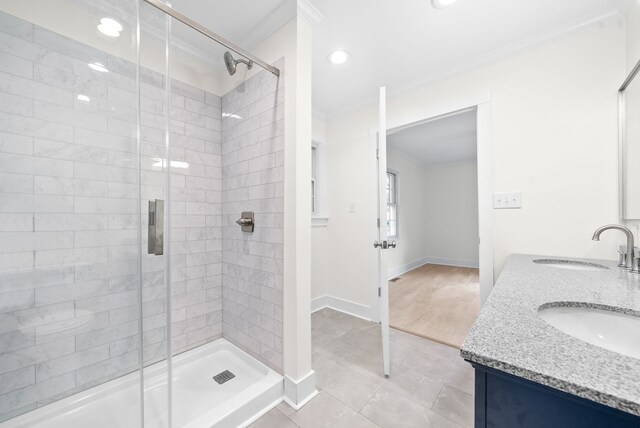 bathroom featuring ornamental molding, hardwood / wood-style floors, vanity, and a shower with door