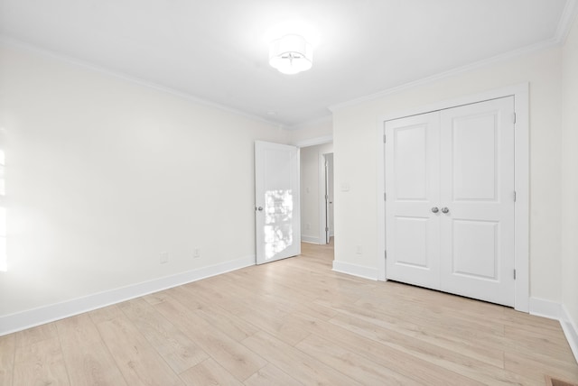 unfurnished bedroom featuring light hardwood / wood-style floors, a closet, and ornamental molding