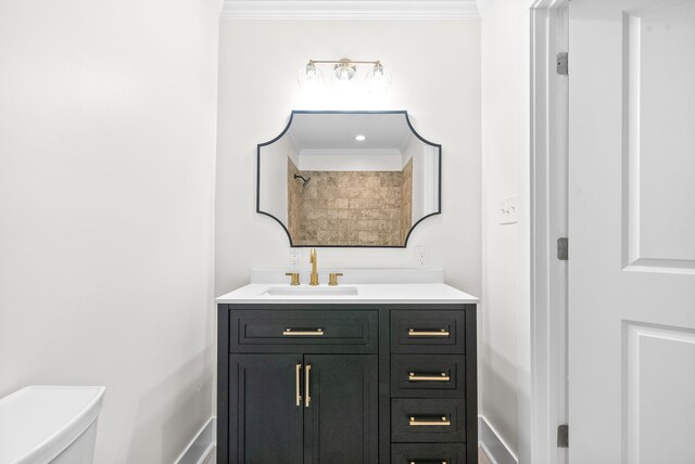 bathroom featuring toilet, crown molding, and vanity