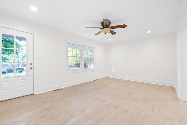 unfurnished room featuring a wealth of natural light, crown molding, light hardwood / wood-style flooring, and ceiling fan