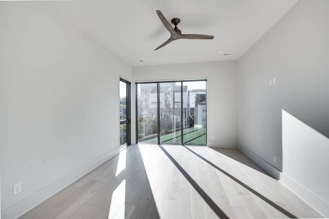 spare room featuring light hardwood / wood-style flooring and ceiling fan