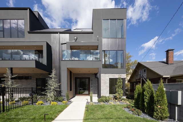 exterior space with a front yard and a balcony