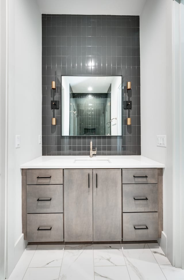 bathroom featuring vanity and backsplash