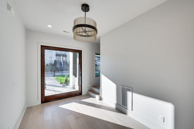 interior space featuring a chandelier and light wood-type flooring