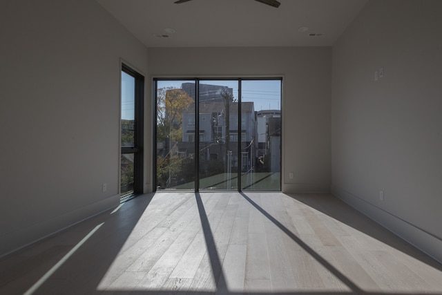 spare room with hardwood / wood-style floors and ceiling fan