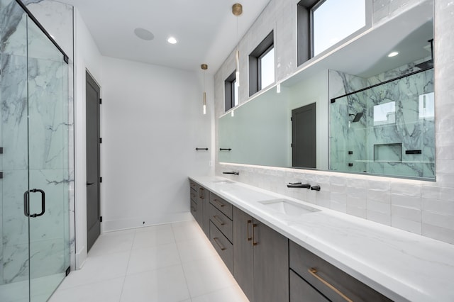 bathroom featuring a shower with door, backsplash, tile patterned flooring, and vanity