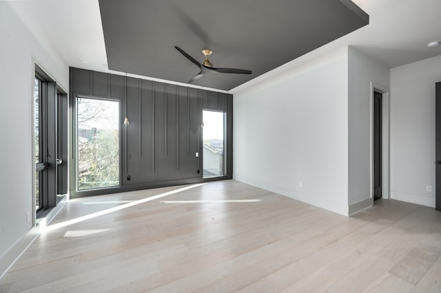 spare room with light hardwood / wood-style flooring and ceiling fan