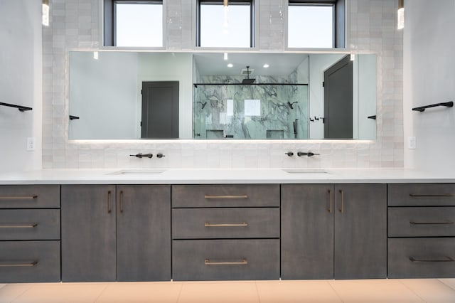 bathroom featuring vanity, backsplash, and an enclosed shower