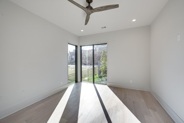 unfurnished room featuring light wood-type flooring and ceiling fan