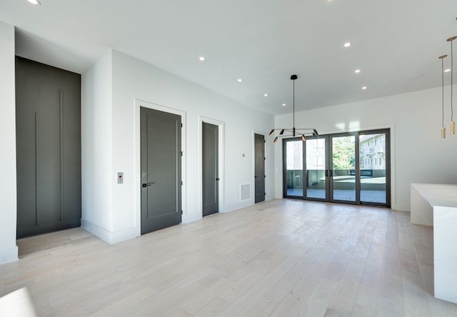 spare room featuring light hardwood / wood-style floors and elevator