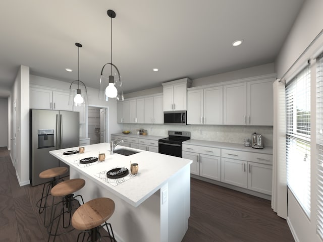 kitchen with sink, appliances with stainless steel finishes, hanging light fixtures, and white cabinetry