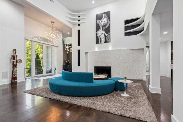 31 Annandale, Nashville, TN 37215 - living room with a towering ceiling, a chandelier, a fireplace, wood finished floors, and baseboards