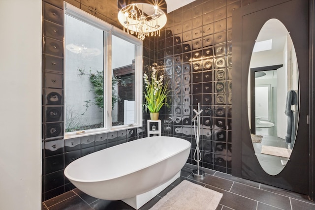 31 Annandale, Nashville, TN 37215 - bathroom featuring a freestanding tub, plenty of natural light, tile patterned floors, and a chandelier