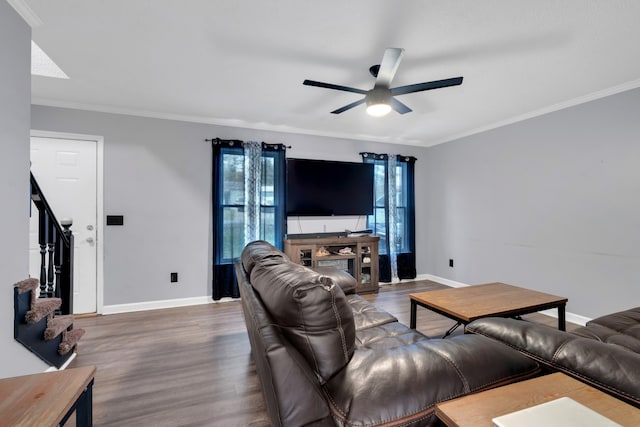 living room featuring ornamental molding, wood-type flooring, and ceiling fan