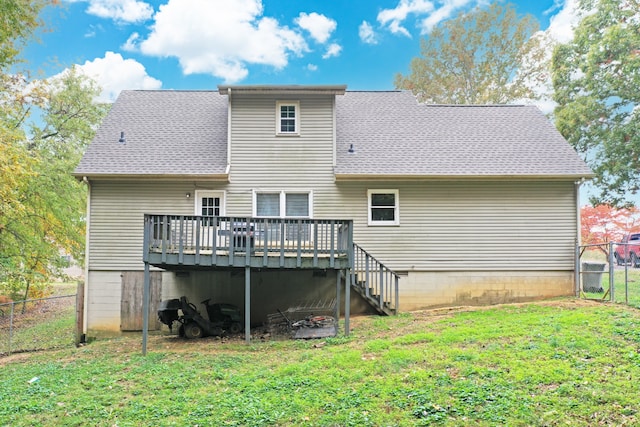 rear view of property featuring a wooden deck and a yard