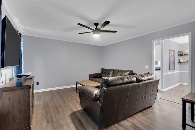 living room with light hardwood / wood-style flooring, ornamental molding, a textured ceiling, and ceiling fan