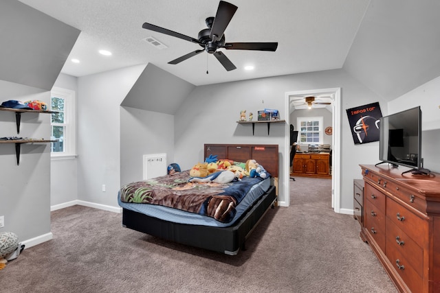 carpeted bedroom featuring ceiling fan, a textured ceiling, and vaulted ceiling