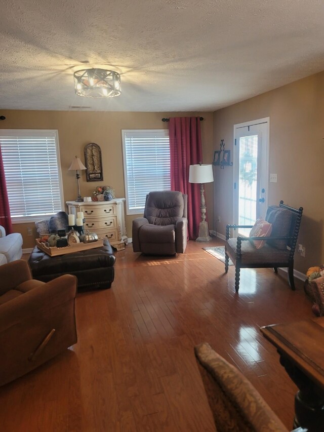 47 Hickory Ln, Sugar Tree, TN 38380 - living room with hardwood / wood-style floors, a textured ceiling, and baseboards