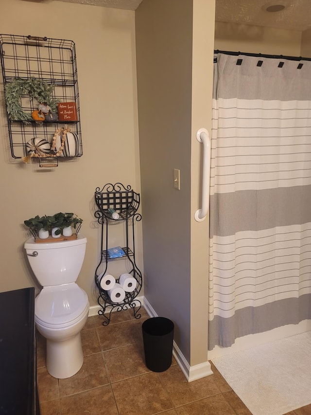 47 Hickory Ln, Sugar Tree, TN 38380 - bathroom with tile patterned floors, a shower with curtain, baseboards, and toilet