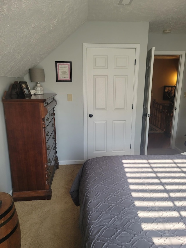 47 Hickory Ln, Sugar Tree, TN 38380 - bedroom featuring carpet floors, a textured ceiling, lofted ceiling, and baseboards